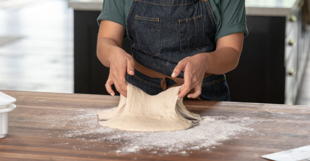 Hannah Dela Cruz demonstrates the slap and fold technique for building dough strength